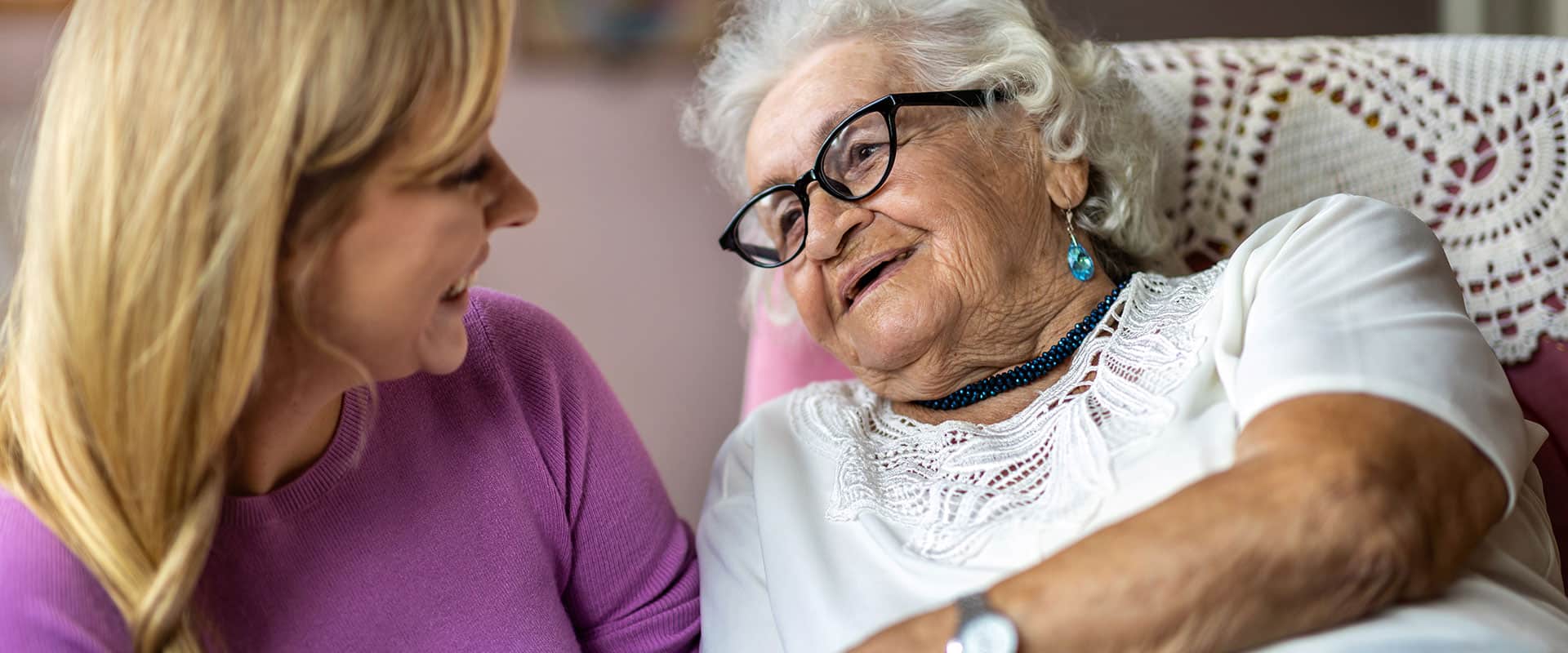 Daughter visiting mother in senior living
