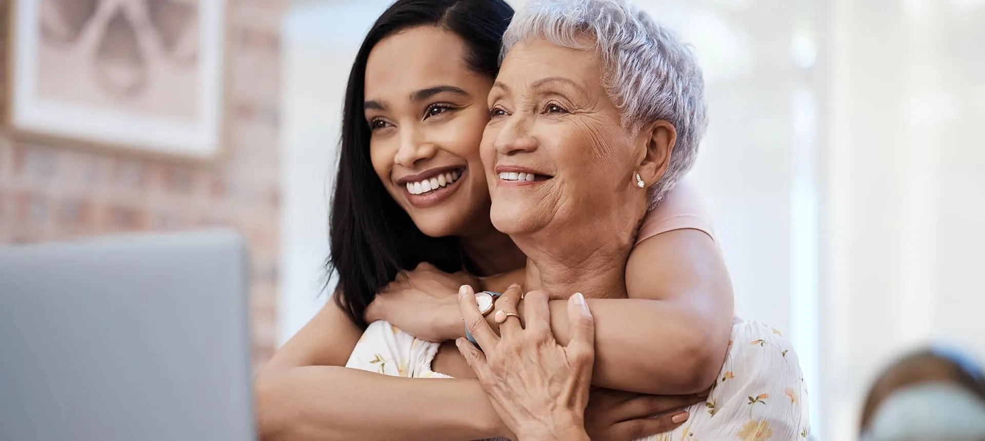 Daughter hugging mother in memory care