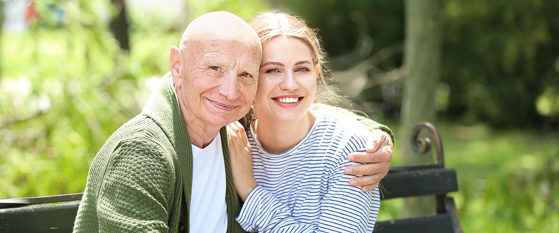 Grandfather and granddaughter on a bench