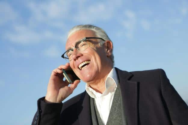 Cheerful senior businessman talking on smartphone on street px | Gadgets for Seniors