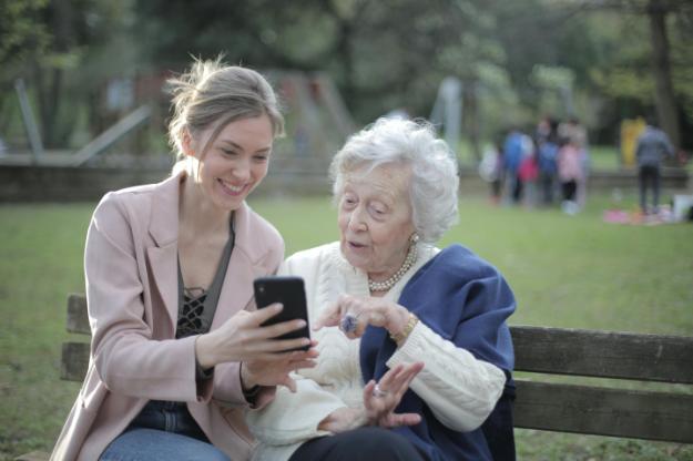 Cheerful senior mother and adult daughter using smartphone together px | Senior Support Organizations