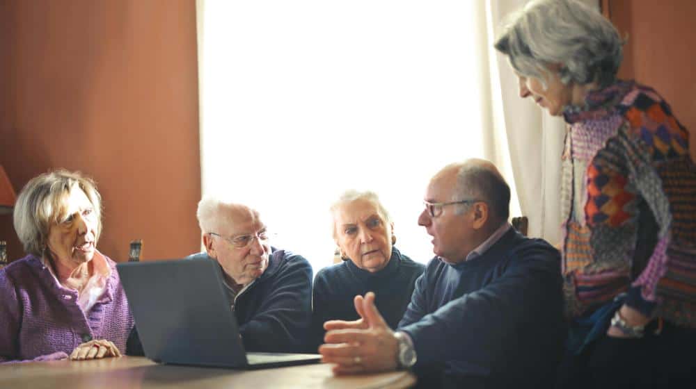 Elderly People Sitting at Table with Laptop px featured image | Senior Support Organizations