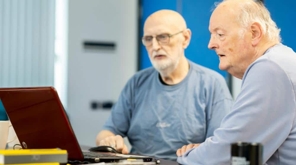 Elderly Men Sitting at Desk with Laptop | Dementia Simulation Training px featured image