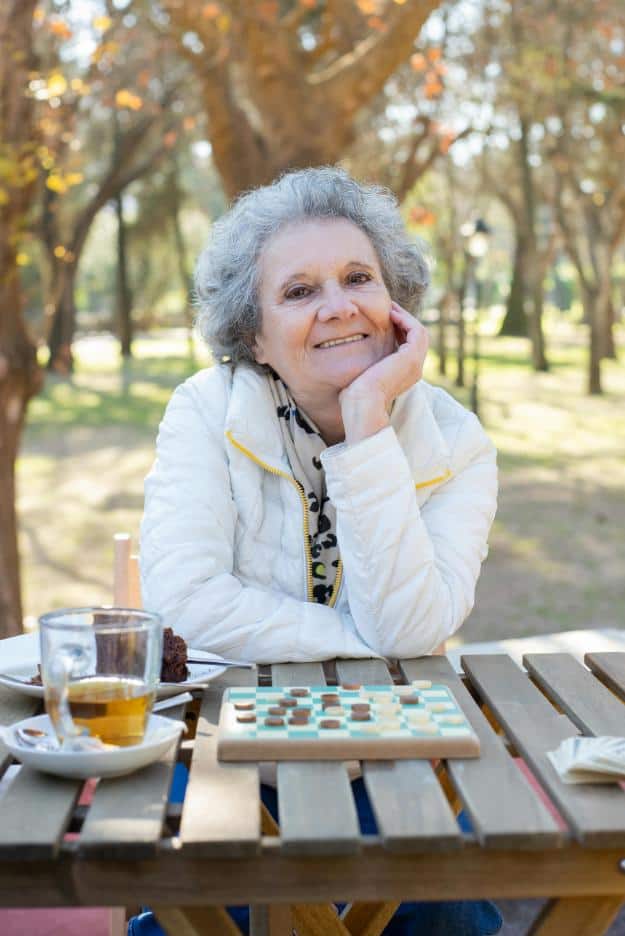 Elderly Woman Sitting by the Table Playing Board Game | Memory Games for Seniors px