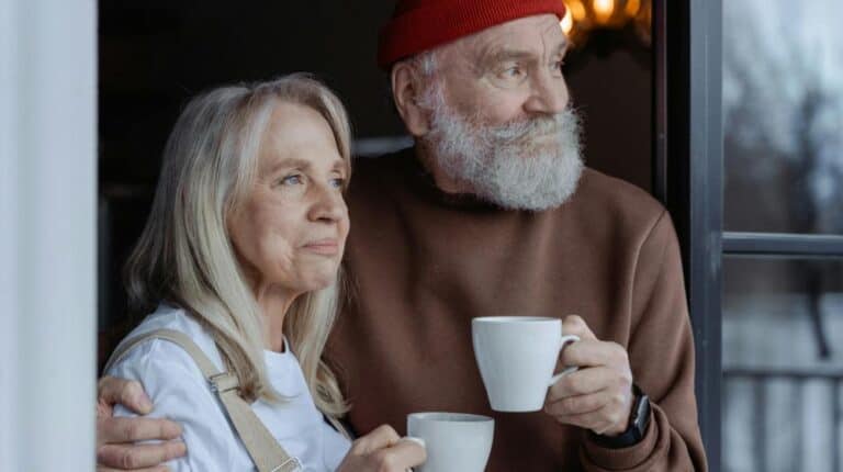 Man and Woman Holding White Ceramic Mugs | camping for seniors px featured image