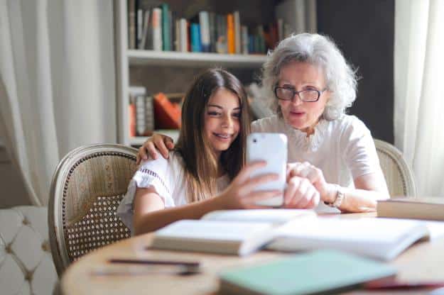 Photo of Woman Showing Her Cellphone to Her Grandmother | teach computer skills to seniors px