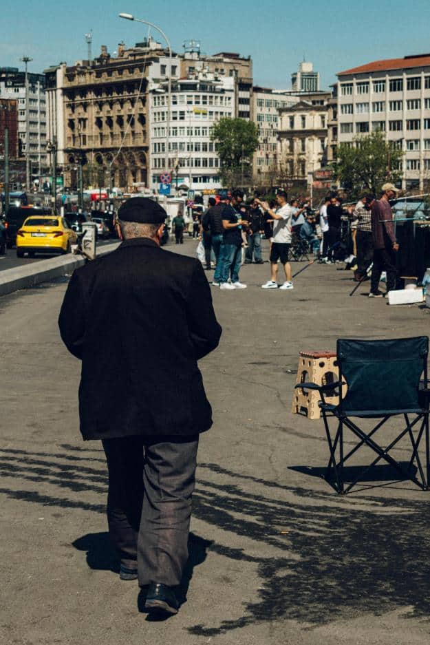 Senior in Black Hat and Jacket Walking on Pavement in City | how to deal with irrational elderly parents px