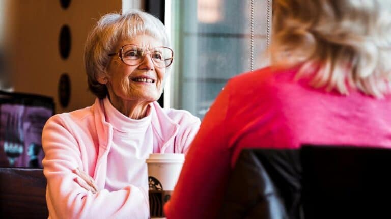 Senior mother and mature daughter in cafe | how to deal with irrational elderly parents px featured image