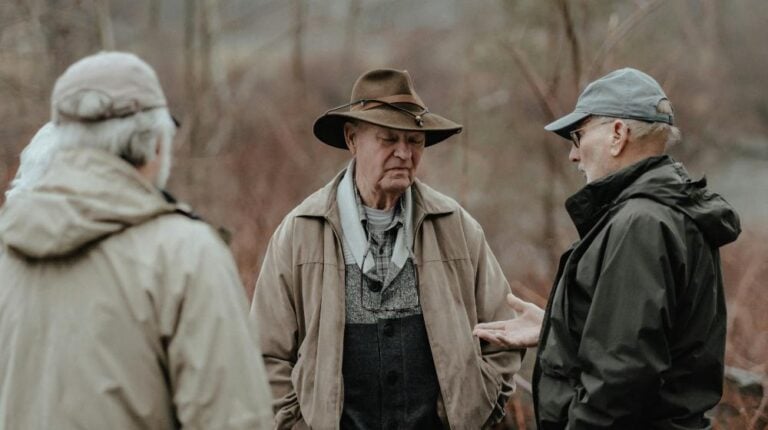 a group of men standing next to each other | Growing Senior Population us featured image