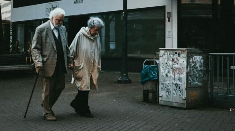 man in black suit standing beside woman in white coat | Credit Card Debt us featured image