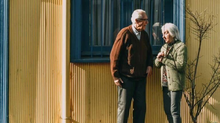 Phases of Retirement | Man and Woman Standing in Front of Building's Window