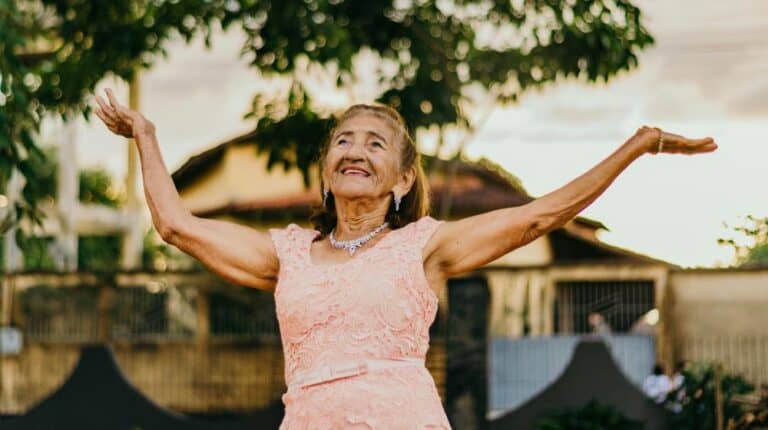 New Senior Living Community | Woman Raising Her Both Hands