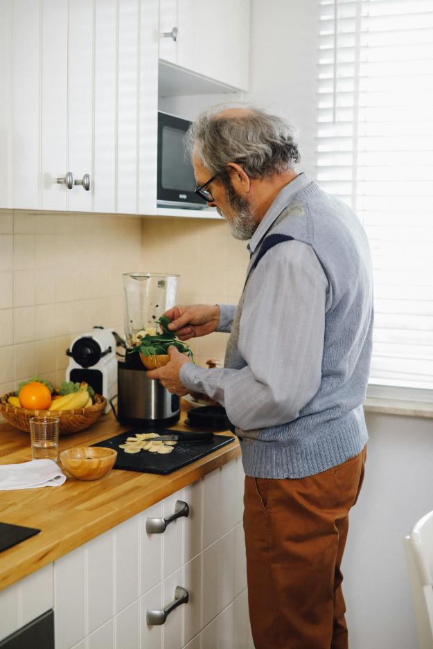 An Elderly Man in Gray Long Sleeves Standing while Holding a Wooden Bowl | Black Friday Gift Ideas for Seniors px