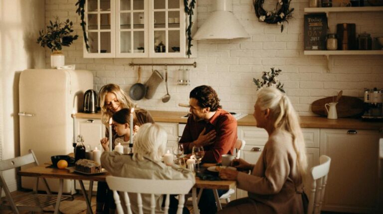 Family Sits on Table Inside Kitchen | Thanksgiving Celebration Ideas for Seniors px featured image