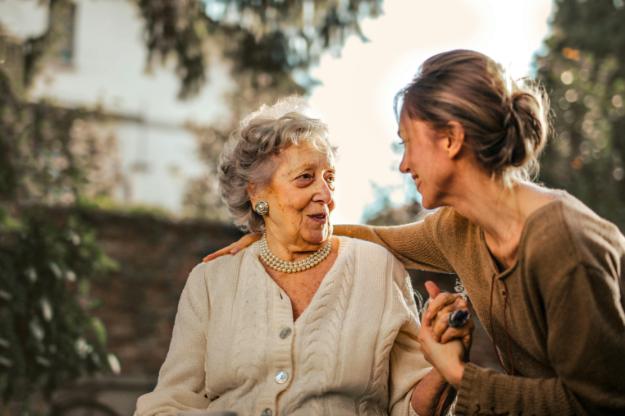 Joyful adult daughter greeting happy surprised senior mother in garden | Thanksgiving Celebration Ideas for Seniors px