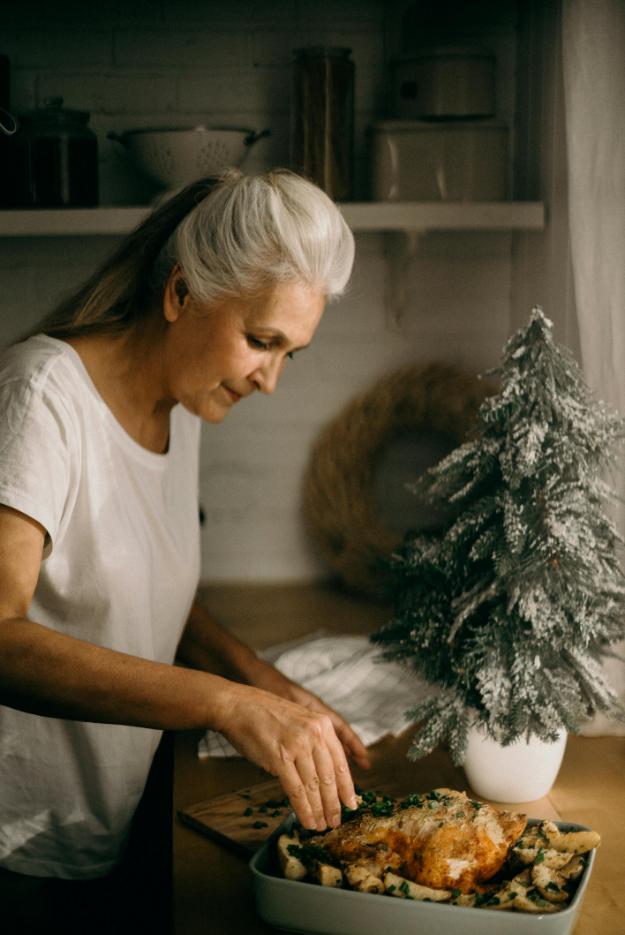 Selective Focus Photography of Standing Woman in Front of Dish | Thanksgiving Celebration Ideas for Seniors px