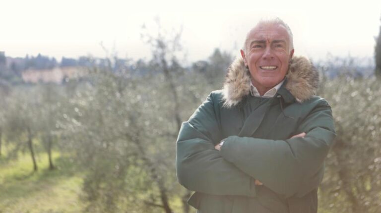 Smiling Man in Green Jacket Standing Near Green Trees | Winter Safety Tips for Seniors px featured image