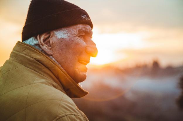 man wearing brown jacket and knit cap | Winter Travel Tips for Seniors us