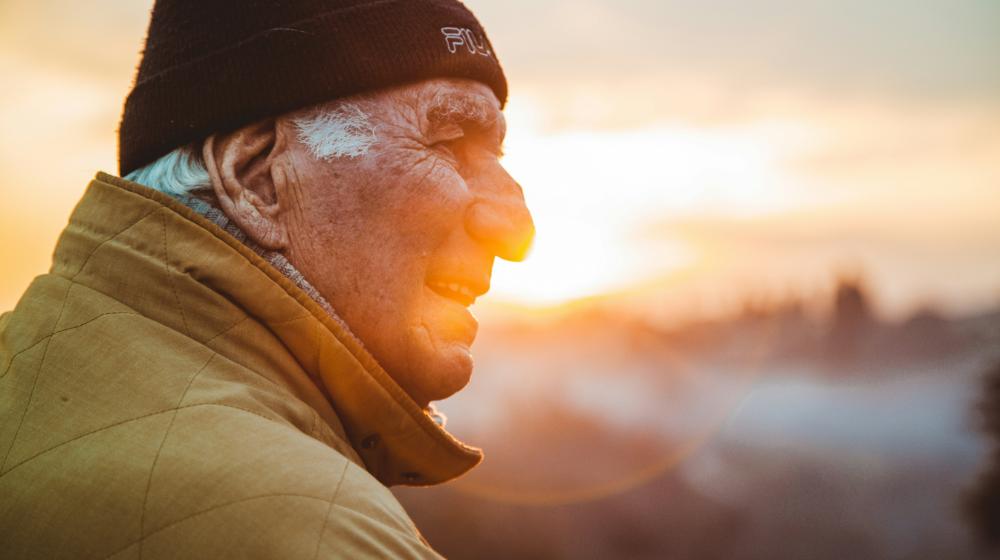 man wearing brown jacket and knit cap featured image us